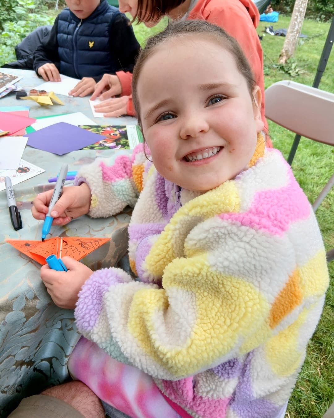 Child smiling during a Midlothian Wildflowers outdoor learning activity